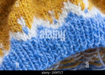 close-up photography of yellow blue white icelandic wool yarn rib, traditional nordic pattern macro photography Stock Photo