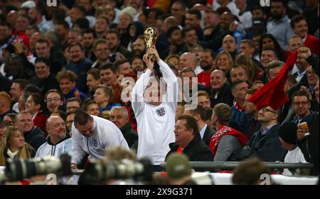 England fan holding up a replica World Cup during England v Slovenia at Wembley Stadium. Stock Photo