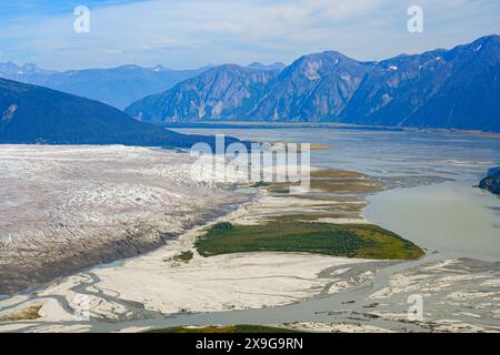 Aerial view of the glaciers located along the Taku Inlet, which are part of the Juneau Icefield in Alaska, USA - Floodplain covered with moraine surro Stock Photo