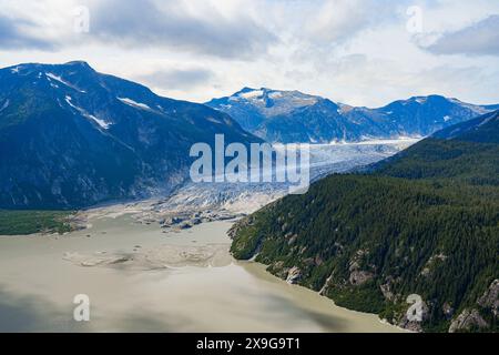 Aerial view of the Taku Glacier which is part of the Juneau Icefield in Alaska, USA - Melting water flowing into the Pacific Ocean displaying evidence Stock Photo