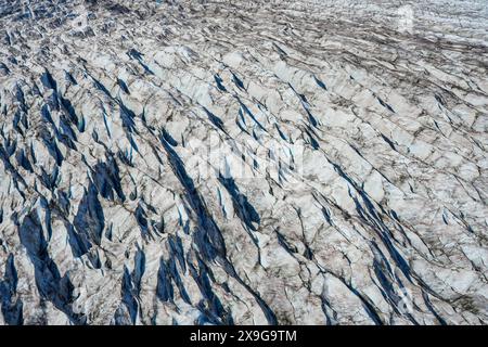 Aerial view of the glaciers located along the Taku Inlet, which are part of the Juneau Icefield in Alaska, USA - Curvy flow of ice covered with shear Stock Photo