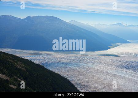 Aerial view of the glaciers located along the Taku Inlet, which are part of the Juneau Icefield in Alaska, USA - Curvy flow of ice covered with shear Stock Photo