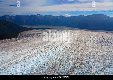 Aerial view of the glaciers located along the Taku Inlet, which are part of the Juneau Icefield in Alaska, USA - Curvy flow of ice covered with shear Stock Photo