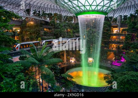Jewel Changi Airport is a new terminal building under a glass dome, with indoor waterfall and tropical forest, shopping malls and dining, in Singapore Stock Photo