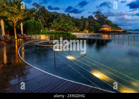 Pool and restaurant of The Ritz-Carlton Langkawi luxury hotel in Langkawi, Malaysia.  Set in a tranquil and private bay, on expansive grounds that are Stock Photo