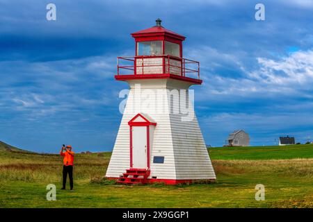 Iles de la Madeleine Cape Alright lighthouse on a cliff overlooking a sandy beach in the Iles de la Madeleine, Quebec, Canada Stock Photo