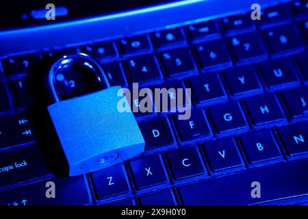 Computer security concept with a closed padlock on the keyboard.padlock on top of a laptop keyboard.Selective focus,close up Stock Photo