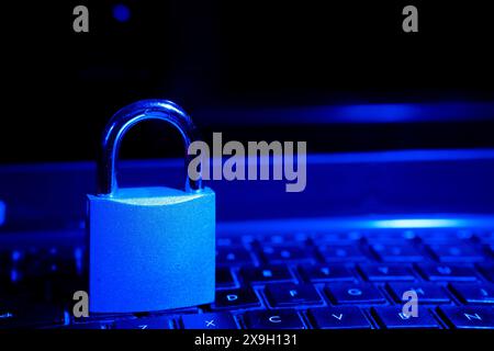 Computer security concept with a closed padlock on the keyboard.padlock on top of a laptop keyboard. Stock Photo
