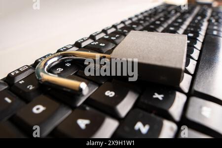 Close up to An open padlock on a computer keyboard Stock Photo