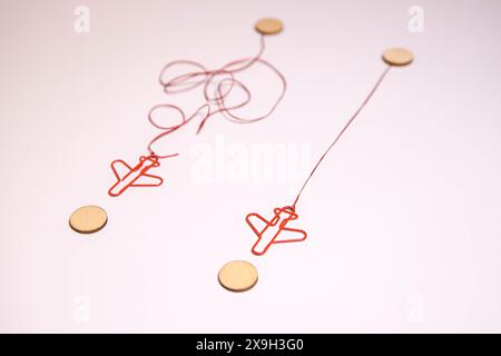 Three paper airplanes take flight in different directions across a blackboard Stock Photo