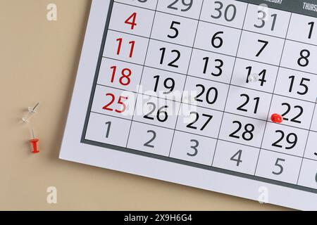 Timetable. Calendar page and drawing pins on beige background, top view Stock Photo