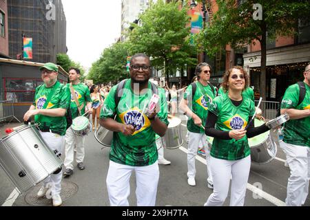 The 18th annual Dance Parade New York moves through Greenwich Village in 2024  to Tompkins Square Park for a five stage dance festival.  Dance Parade New York is the world’s only parade to exclusively celebrate and showcase the diversity of dance. By showcasing various genres, cultures, and styles, the parade and post-parade festival unify the world of dance. It also provides the general public the opportunity to experience and participate in a day of dance. Samba New York Dancers. Stock Photo
