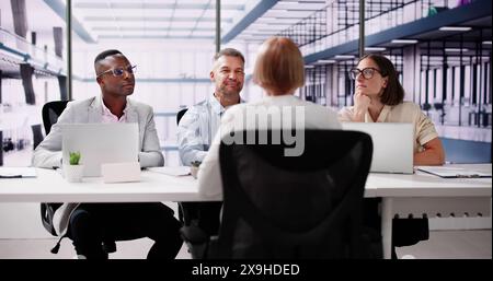 Young Woman Sitting At Interview In Office Stock Photo