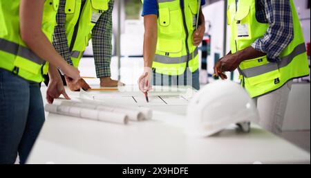 Civil Engineer Or Architect Team With Construction Plans Stock Photo