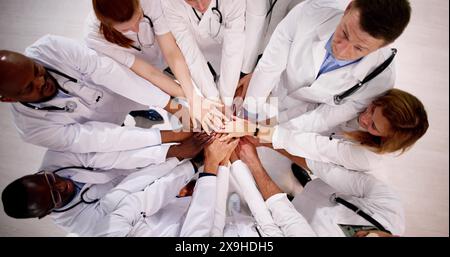 Medical Team Stacking Hands Against In Hospital Stock Photo