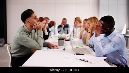 Diverse Tired Young Businesspeople Bored During Meeting In Office Stock Photo