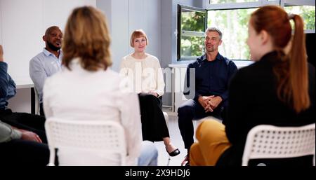 People Consoling Man In Group Therapy Session Stock Photo