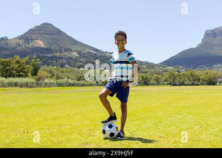 A biracial boy stands confidently in front of blue lockers Stock Photo ...
