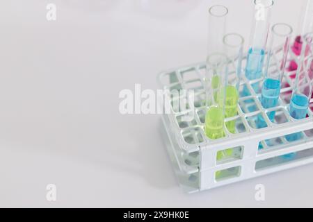 Test tubes with colorful liquids in a laboratory rack, with copy space. These tubes indicate a scientific experiment or research in progress at a lab. Stock Photo