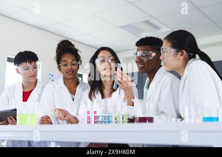 Diverse students engage in a science experiment at high school Stock Photo