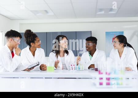 Diverse students engage in a science experiment at high school Stock Photo