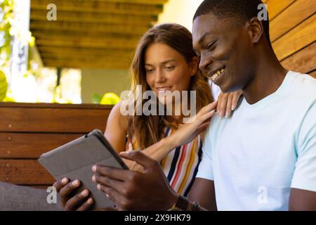 A diverse young couple studying tablet at home Stock Photo