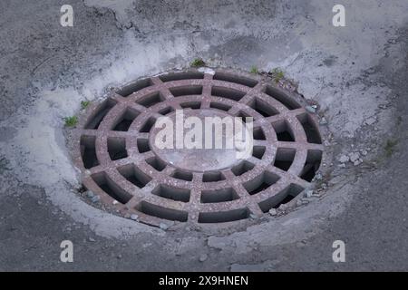 Cast-iron manhole cover storm sewer close-up. Stock Photo