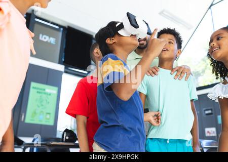 In school, diverse group of young students are exploring virtual reality Stock Photo