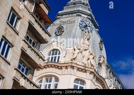 Sofia, Bulgaria. May 23, 2024. Close-up of a beautiful building showing a sculpture of a woman with two children and a clock on top of it. Stock Photo