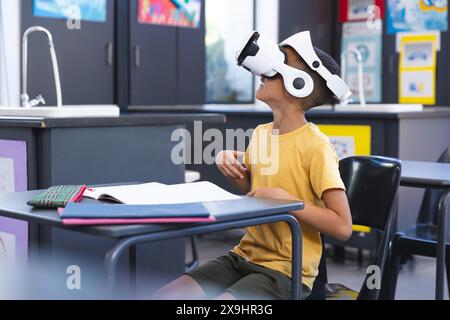 Biracial boy explores virtual reality in school Stock Photo