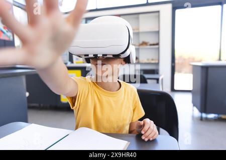 Biracial boy explores virtual reality at school Stock Photo