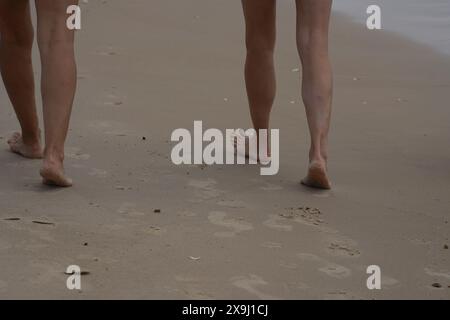 Feet barefoot walking on the sand beach Stock Photo