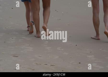Feet barefoot walking on the sand beach Stock Photo