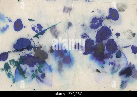 Authentic black and blue ink stains on white kitchen paper Stock Photo