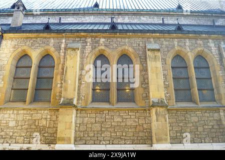 Fragment of the facade of the Cathedral of the Sacred Heart of Jesus in Sarajevo from the western side: a stone wall with windows in the Gothic style Stock Photo