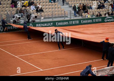 (240601) -- PARIS, June 1, 2024 (Xinhua) -- Staff pull over the rain cover on the court during the women's singles third round match at the French Open tennis tournament at Roland Garros in Paris, France, June 1, 2024. (Xinhua/Meng Dingbo) Stock Photo