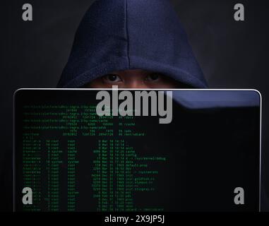 Laptop, screen and portrait of hacker in studio for ransomware, cyber attack and crime on server. Cybersecurity, fraud and man with technology for Stock Photo