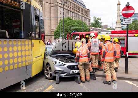 A car crashed into a tram in St Peters square after traffic was stopped in the centre due to a Palestinian demonstration in Manchester city centre. The protest saw protesters pass down Market street passing a Barclays Bank branch which has been boarded up after windows were smashed and the building was covered in red paint as part of a protest againts the Banks involvement with investment in Israel. Manchester, UK  Picture: garyroberts/worldwidefeatures.com Stock Photo