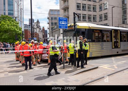 A car crashed into a tram in St Peters square after traffic was stopped in the centre due to a Palestinian demonstration in Manchester city centre. The protest saw protesters pass down Market street passing a Barclays Bank branch which has been boarded up after windows were smashed and the building was covered in red paint as part of a protest againts the Banks involvement with investment in Israel. Manchester, UK  Picture: garyroberts/worldwidefeatures.com Stock Photo