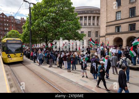 A car crashed into a tram in St Peters square after traffic was stopped in the centre due to a Palestinian demonstration in Manchester city centre. The protest saw protesters pass down Market street passing a Barclays Bank branch which has been boarded up after windows were smashed and the building was covered in red paint as part of a protest againts the Banks involvement with investment in Israel. Manchester, UK  Picture: garyroberts/worldwidefeatures.com Stock Photo