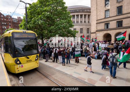 A car crashed into a tram in St Peters square after traffic was stopped in the centre due to a Palestinian demonstration in Manchester city centre. The protest saw protesters pass down Market street passing a Barclays Bank branch which has been boarded up after windows were smashed and the building was covered in red paint as part of a protest againts the Banks involvement with investment in Israel. Manchester, UK  Picture: garyroberts/worldwidefeatures.com Stock Photo