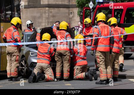 A car crashed into a tram in St Peters square after traffic was stopped in the centre due to a Palestinian demonstration in Manchester city centre. The protest saw protesters pass down Market street passing a Barclays Bank branch which has been boarded up after windows were smashed and the building was covered in red paint as part of a protest againts the Banks involvement with investment in Israel. Manchester, UK  Picture: garyroberts/worldwidefeatures.com Stock Photo