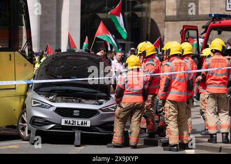 A car crashed into a tram in St Peters square after traffic was stopped in the centre due to a Palestinian demonstration in Manchester city centre. The protest saw protesters pass down Market street passing a Barclays Bank branch which has been boarded up after windows were smashed and the building was covered in red paint as part of a protest againts the Banks involvement with investment in Israel. Manchester, UK Picture: garyroberts/worldwidefeatures.com Stock Photo