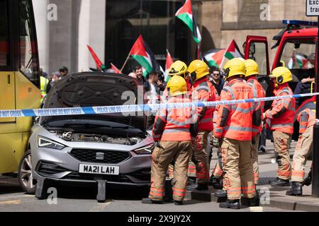 A car crashed into a tram in St Peters square after traffic was stopped in the centre due to a Palestinian demonstration in Manchester city centre. The protest saw protesters pass down Market street passing a Barclays Bank branch which has been boarded up after windows were smashed and the building was covered in red paint as part of a protest againts the Banks involvement with investment in Israel. Manchester, UK Picture: garyroberts/worldwidefeatures.com Stock Photo