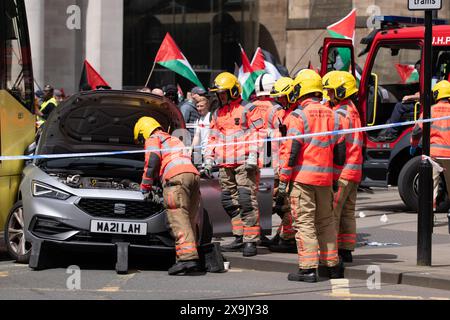 A car crashed into a tram in St Peters square after traffic was stopped in the centre due to a Palestinian demonstration in Manchester city centre. The protest saw protesters pass down Market street passing a Barclays Bank branch which has been boarded up after windows were smashed and the building was covered in red paint as part of a protest againts the Banks involvement with investment in Israel. Manchester, UK  Picture: garyroberts/worldwidefeatures.com Stock Photo