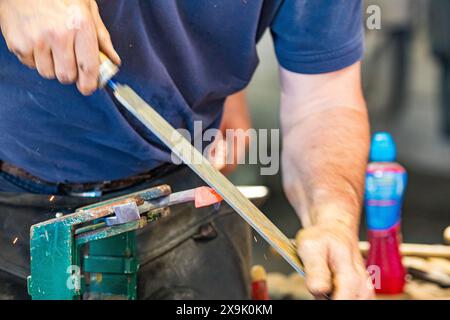 SHEPTON MALLET, SOMERSET, UK. 1st June, 2024,  close up and detail shots Farriers making horseshoes in forges and fitting them to horses in the  apprentice class shoeing at the Royal Bath and West Show 2024. Credit John Rose/Alamy Live News Stock Photo