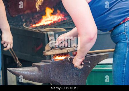 SHEPTON MALLET, SOMERSET, UK. 1st June, 2024,  close up and detail shots Farriers making horseshoes in forges and fitting them to horses in the  apprentice class shoeing at the Royal Bath and West Show 2024. Credit John Rose/Alamy Live News Stock Photo