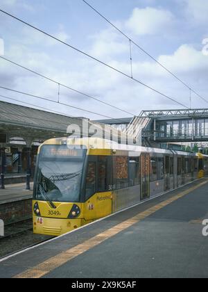 Bee Network Metrolink tram to Manchester Piccadilly as seen at Altrincham Interchange Stock Photo