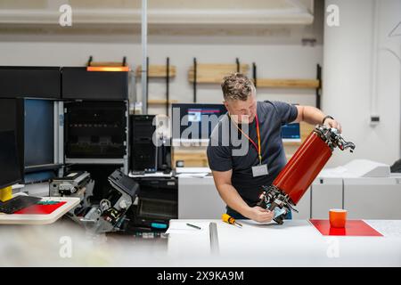 Maintenance engineer in a in printing house fixing machine Stock Photo
