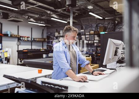 Man working in a printing factory Stock Photo